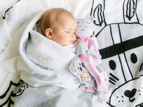 Baby sleeping on organic cotton muslin wrap