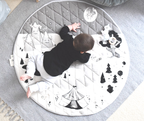 Baby crawling on organic cotton play mat