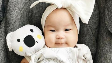 Baby holding Banjo Kippin comfort toy