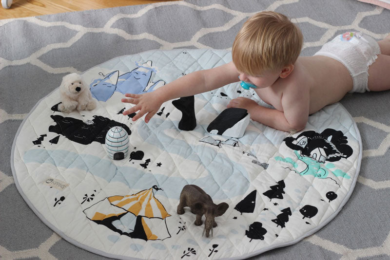 Baby playing with toys on Kippins play mat