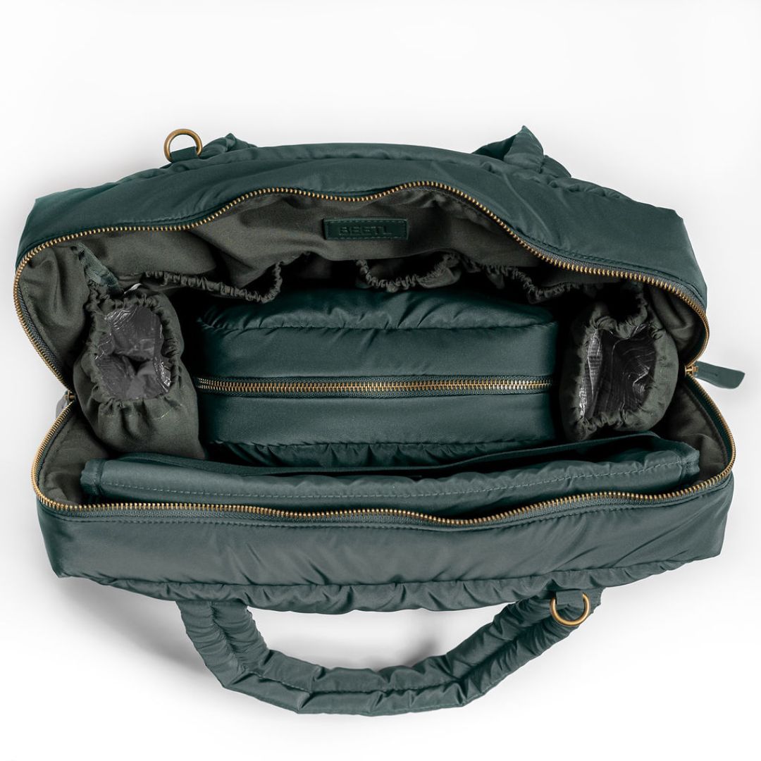 Forest green BEETL baby bag showing multiple compartments and adjustable straps for easy carrying and organization.