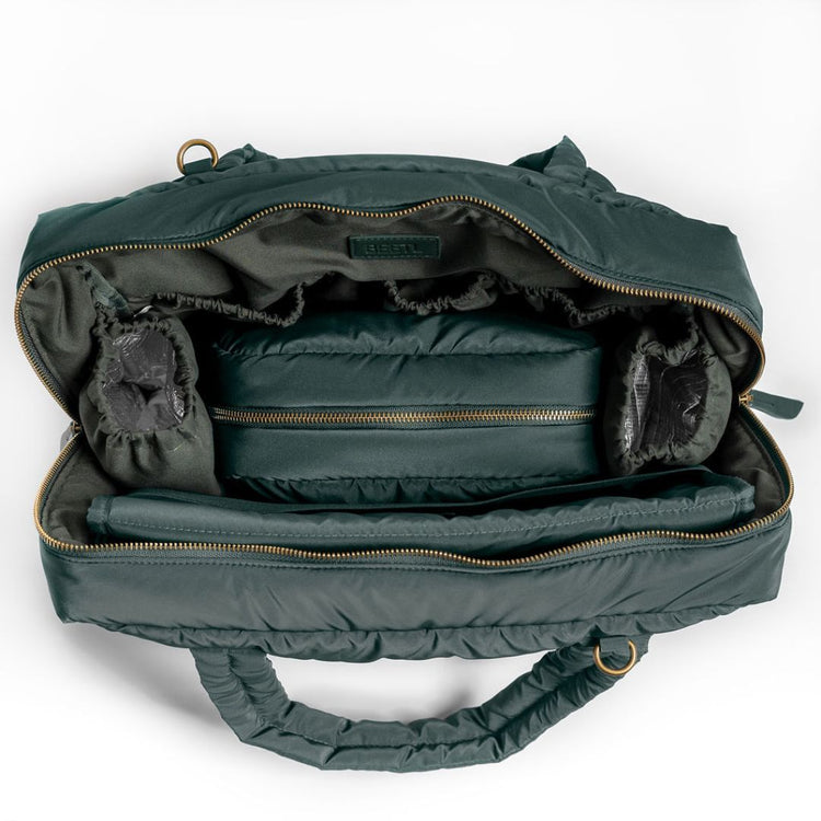 Forest green BEETL baby bag showing multiple compartments and adjustable straps for easy carrying and organization.
