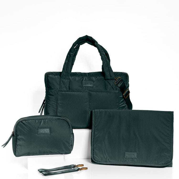 Forest green BEETL baby bag with multiple compartments and adjustable straps, designed for parent convenience and style.