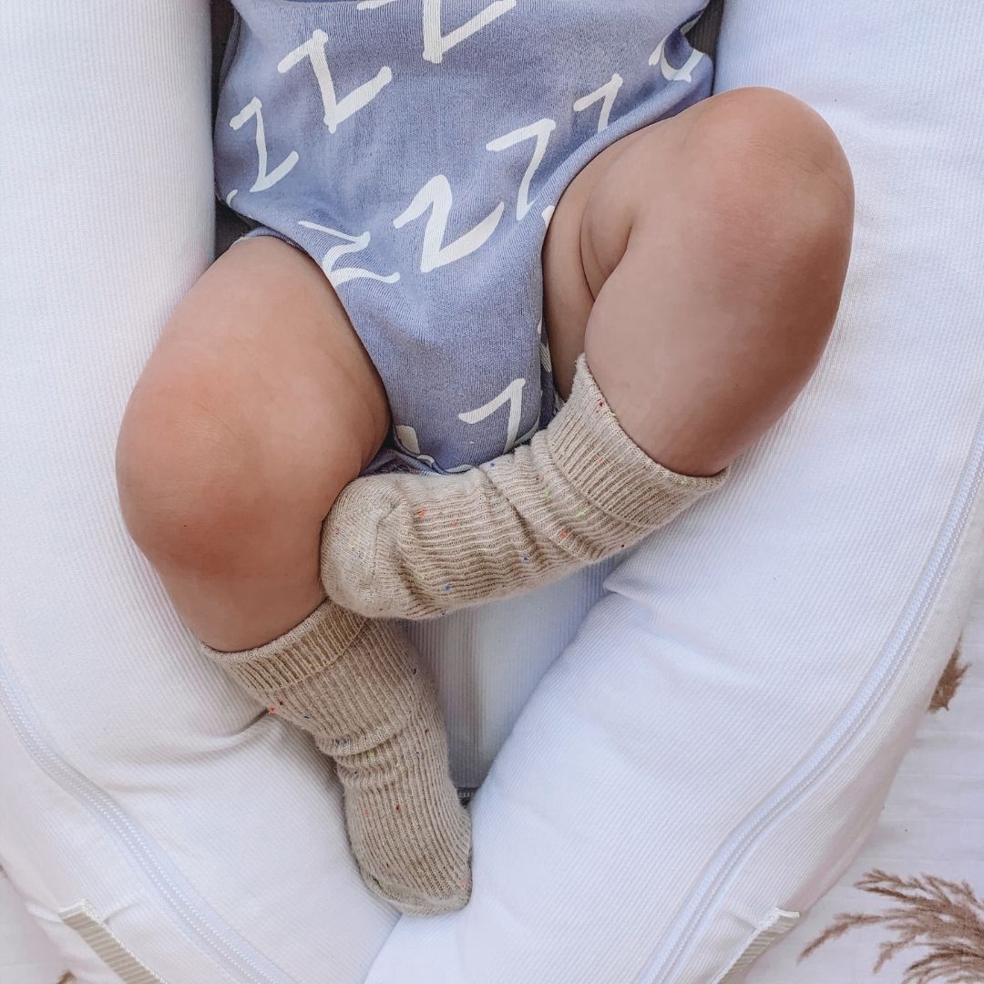Kippins Bam short sleeve baby bodysuit in light fabric, featuring a simple design for infants aged 0-3 months.