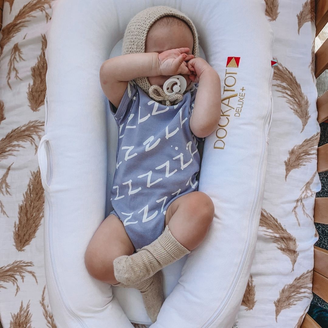 Kippins Bam short sleeve bodysuit for babies, showing soft fabric and snap closures in size 0-3 months.