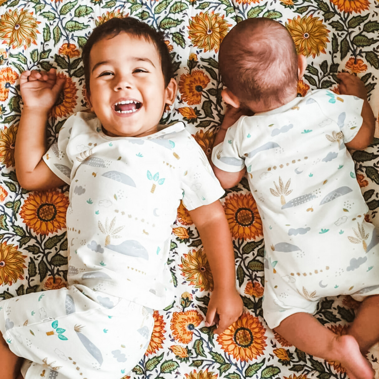 Kippins Desert short sleeve bodysuit for babies, soft fabric with desert-themed print, designed for comfort and easy dressing.