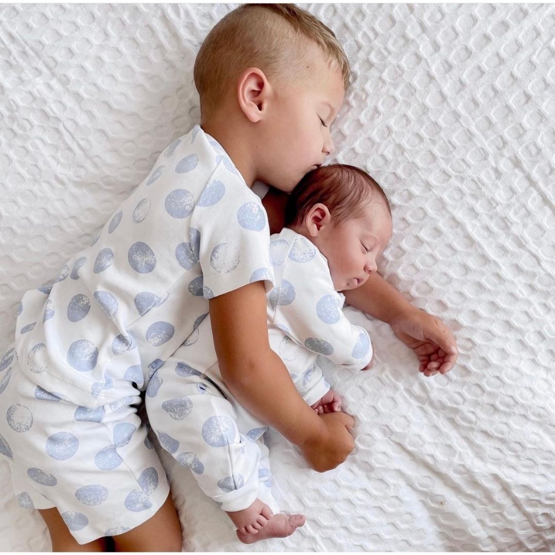 Kippins Luna organic cotton short pajama for kids, soft and comfy, featuring playful moon print and lightweight fabric.